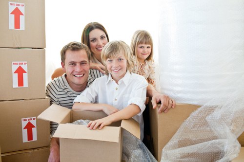 Professional movers handling bulky furniture on a residential street