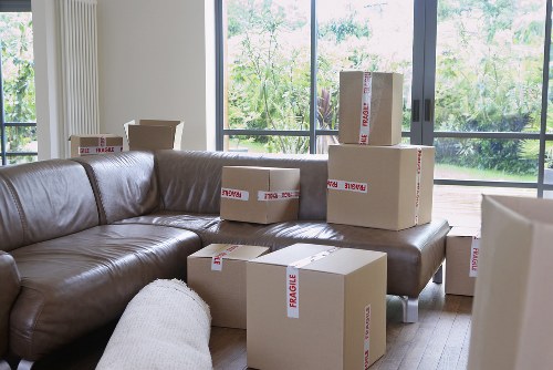 Removals team carrying items through a narrow stairwell in a shared house