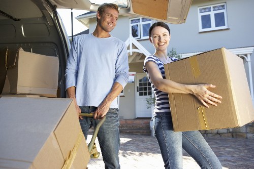 Office desks, equipment, and storage items being moved for an Ilford business